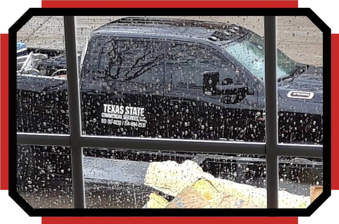 a photo of a Texas state commercial services truck taken from behind a window on a rainy day